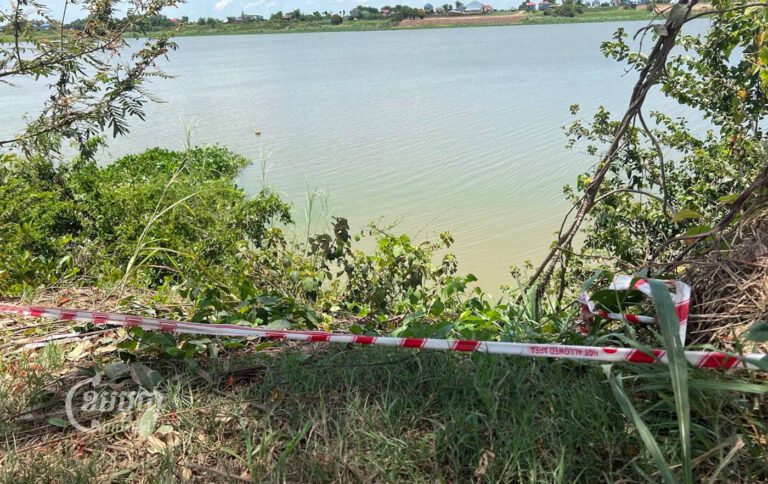 Police tape encloses a section of the Tonle Sap riverbank where two suitcases were found that contained the body of Yi Ming Dali, on June 14, 2023. (CamboJA/Leila Goldstein)