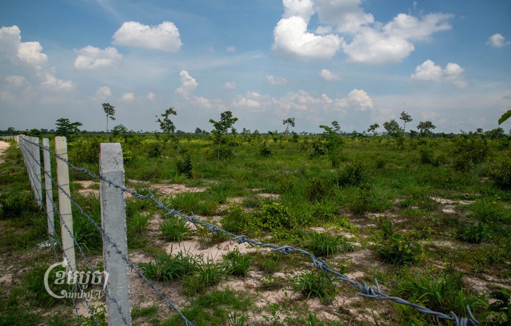 A barbed wire fence surrounds the Phnom Tamao Botanical Garden, which remains largely devoid of trees on June 27, 2023. (Andrew Califf/CamboJA)