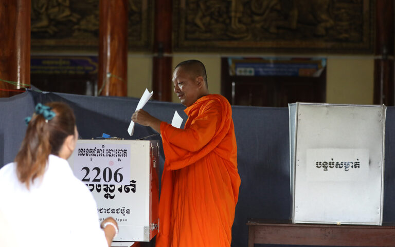A monk votes at a polling station in Phnom Penh on July 23, 2023. (CamboJA/Pring Samrang)