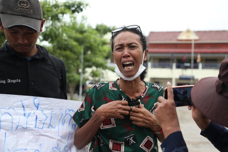 In Thou, a member of the 197 Land Community, is comforted by her son upon hearing the court verdict for 10 Koh Kong land activists, on August 15 2023. (Supplied by Licadho)