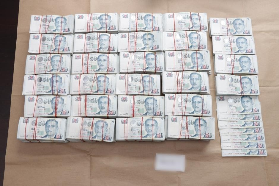 Photos released by the Singaporean police show stacks of cash belonging to the money laundering suspects. More than $16 million in hard cash alone was seized during the city-wide raid.
