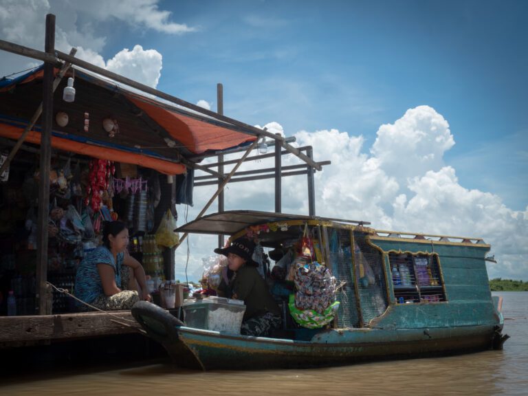 Two sellers meet on the former site of Chhnok Trou village on the Tonle Sap, where villagers were evicted in 2018. Many have returned to the area to maintain their livelihoods.