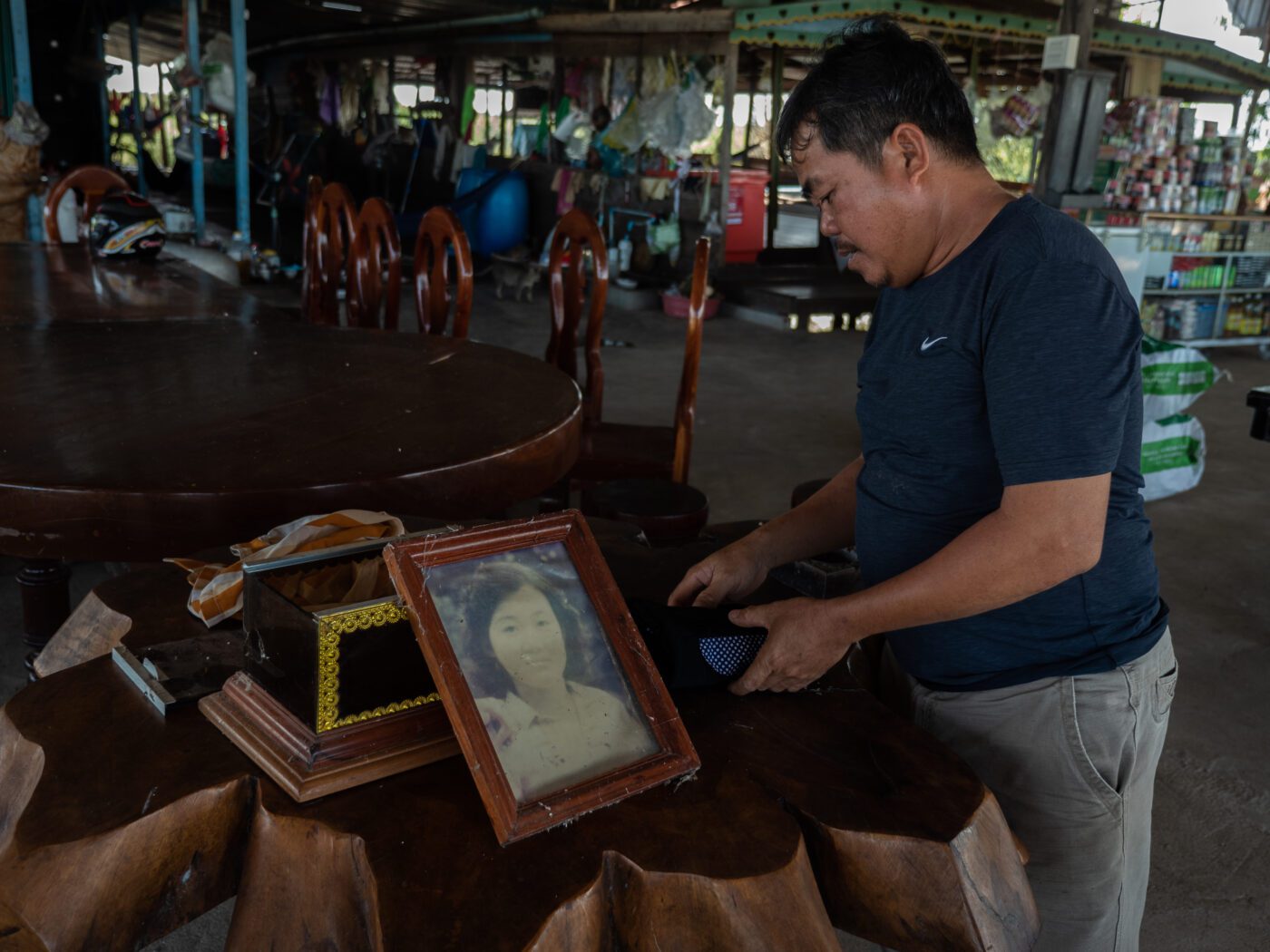 Hak Yang Phoeuk with a portrait of his sister Mak Thy Mai, who was killed in a 1998 attack by Khmer Rouge militants targeting ethnic Vietnamese residents of Chhnok Trou village.