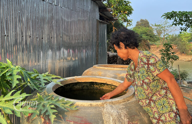 A resident of Bak Rotes village in Battambang province who does not have access to clean water, photographed on March 12, 2023. She uses water from Sangke River and hopes the authorities will provide clean water to villagers soon. (CamboJA/ Sovann Sreypich)