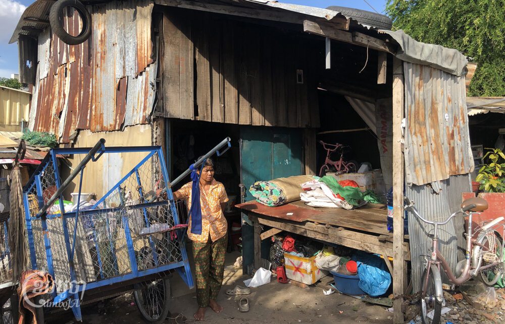Say Saroeun stands next to her handcart in front of her rental home in a poor community in Tuol Kork, on September 26, 2023. (CamboJA/Seoung Nimol)
