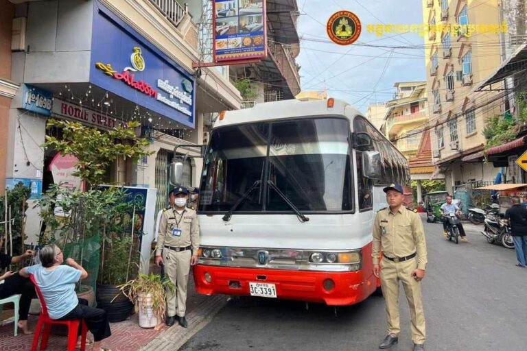 A photo posted on the General Department of Immigration’s Facebook page shows Cambodian officials outside Aladdin Restaurant and Guesthouse with a large bus.