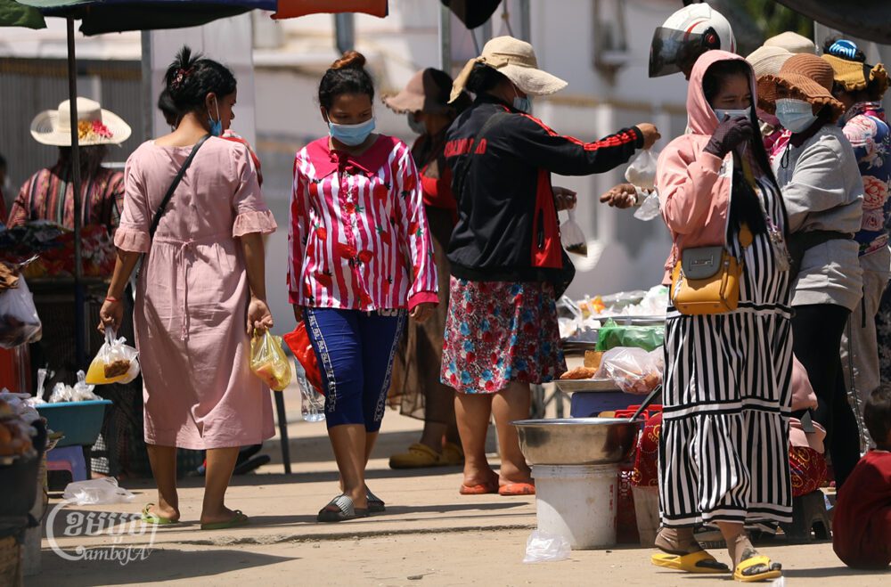 Pregnant garment workers buy food during lunch time in Kandal province on June 4, 2021. (CamboJA/ Pring Samrang)