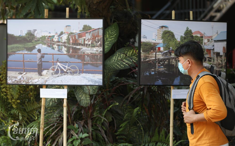 A young man views the photos displayed at Champei Garden Restaurant in Prek Pra commune on February 23, 2024. (CamboJA / Pring Samrang)