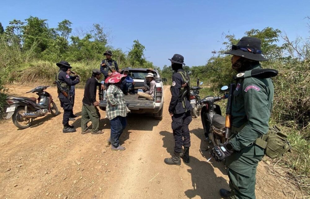 Armed officers stopped a car driving through the protracted area, while one officer was taking photos. (Pursat Provincial Environment’s Facebook)