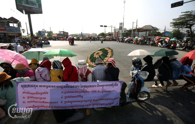 Y&W Garment workers block the road on the outskirts of Phnom Penh as a part of their protest to demand a solution from the government, on March 22, 2024. (CamboJA/Pring Samrang)