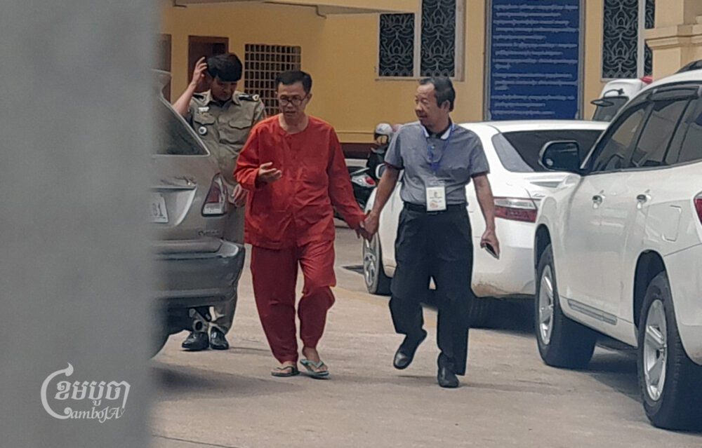 Meu Senghor leaves the Supreme Court with his party advisor Rong Chhun on May 31, 2024. (CamboJA/Va Sopheanut)