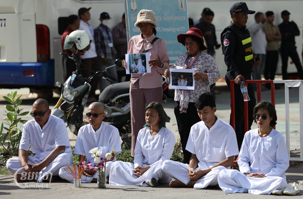 Mother Nature activists meditate outside Phnom Penh Municipal Court having boycotted their second hearing, June 5, 2024. (CamboJA/Pring Samrang)